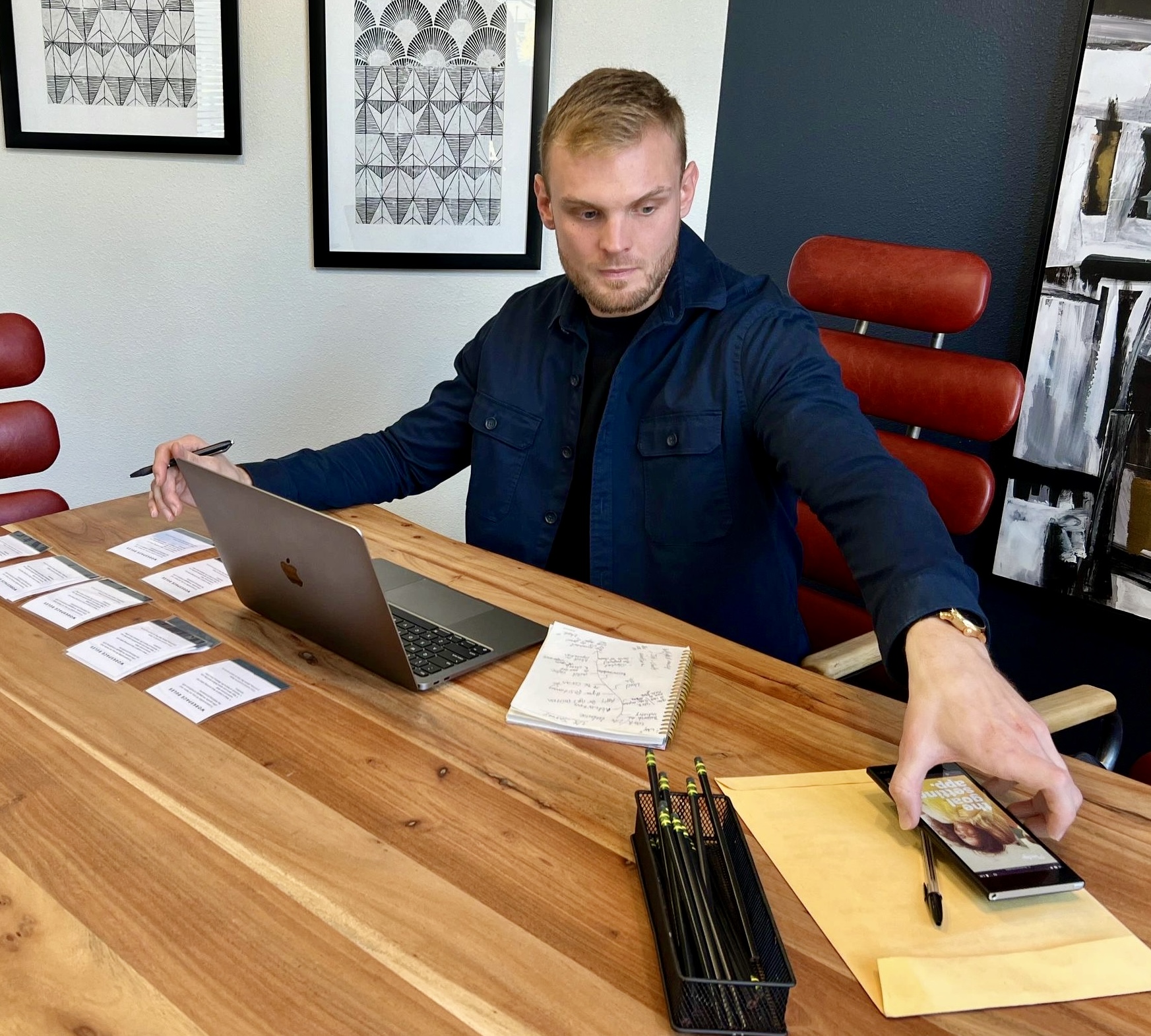 Hayden Doughty working at a desk with research notes